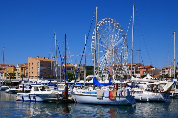 Boats and a big wheel in Athe Harbour at Agde.