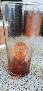 Add the ice, lemon and bitters to the glass and roll the glass to coat it with bitters.
